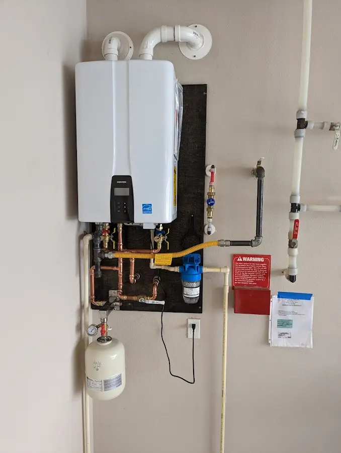 Professional plumber installing copper piping in a Franklin Farm home